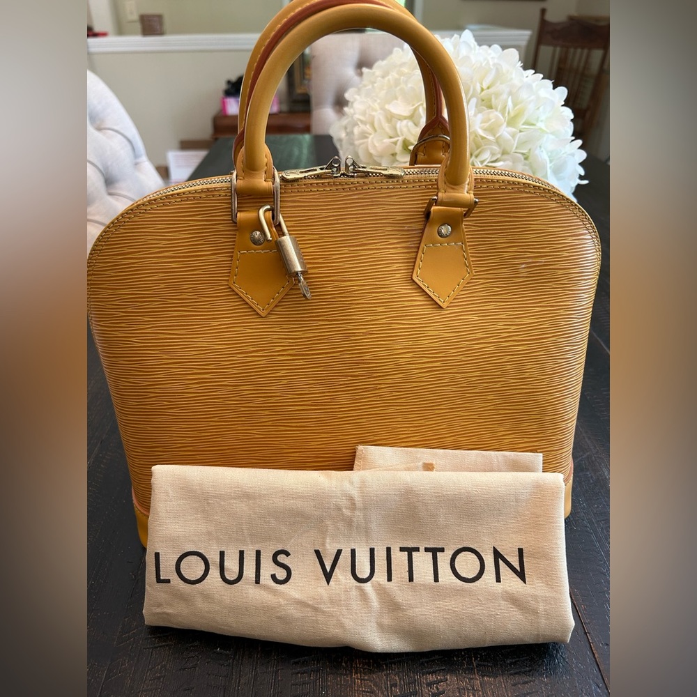 Louis Vuitton Epi Yellow Alma in GUC.  Includes lock and key set and Dustbag.